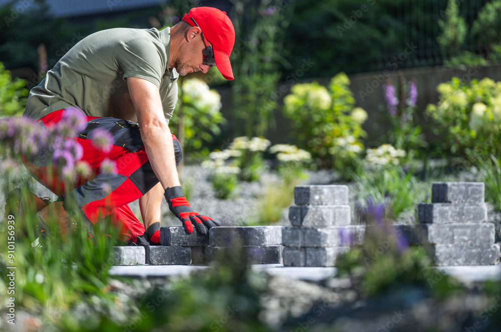 Fototapeta premium Laying Pavers in a Garden During Daylight Hours
