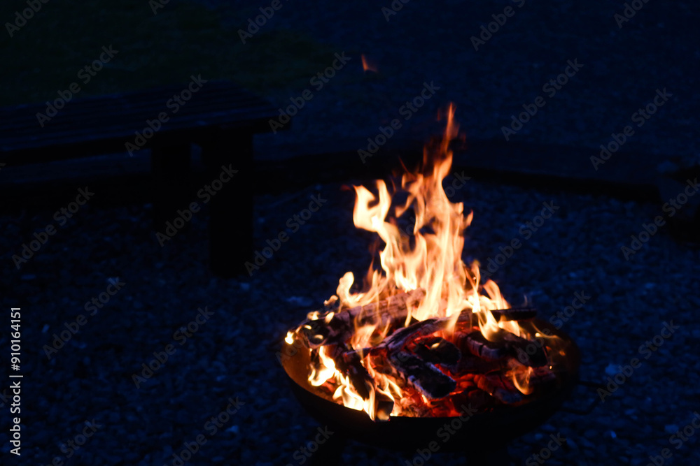 Obraz premium close up of fire flame in a campfire of burning wood charcoal at night in an outdoor area
