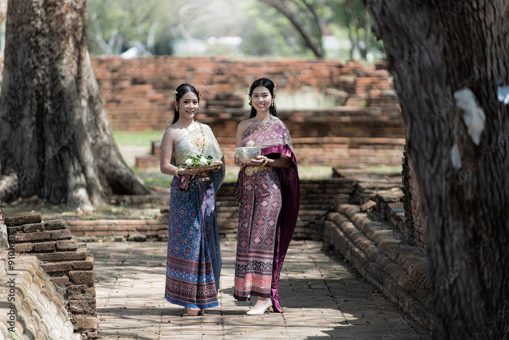 Asia woman in Thai dress traditional women in traditional Dress on Buddhist on background. Portrait women in traditional clothing , Thai traditional in Ayutthaya Thailand.thai model portrait