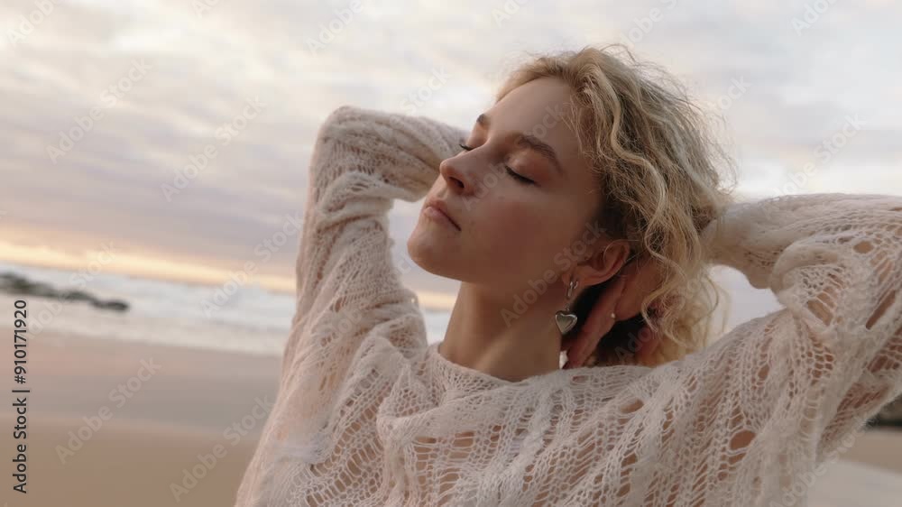 Closeup of a young woman in white clothing dancing gracefully by the ocean at sunset, embodying harmony and the beauty of nature. Closeup of a young woman in white clothing dancing gracefully by the ocean at sunset, embodying harmony and the beauty of nature.