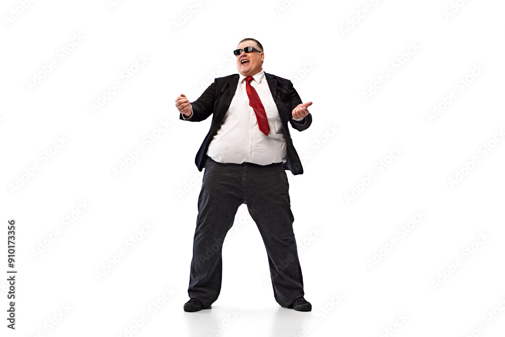 Obraz premium Taking dynamic break. Overweight man in black suit, white shirt and sunglasses, employee dancing, relaxing isolated on white background. Concept of business, leisure, achievement