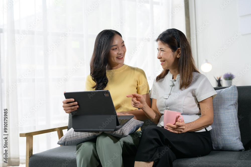 Mother and Daughter Enjoying Quality Time Together at Home with Digital Tablet and Coffee Mother and Daughter Enjoying Quality Time Together at Home with Digital Tablet and Coffee