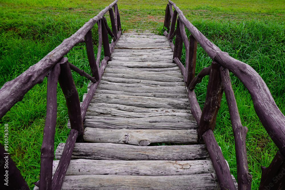Wood bridge made from timber middle on the green paddy field. Wood bridge made from timber middle on the green paddy field.