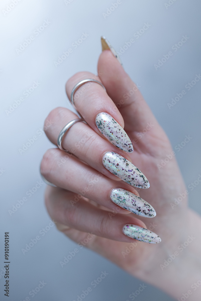 beautiful female hands with long nails light white and green manicure