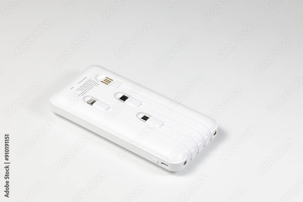 New model of Power bank or External battery with Ready-made charging cable for charging mobile devices, isolate on white background. New model of Power bank or External battery with Ready-made charging cable for charging mobile devices, isolate on white background.