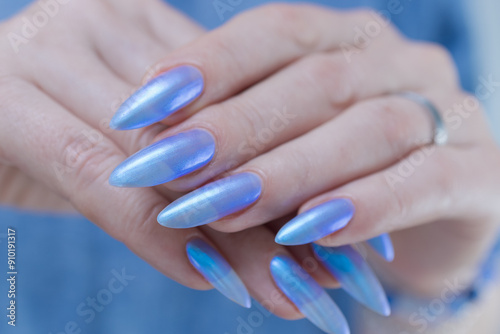 Female hand with long nails and light baby blue manicure