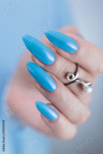 beautiful hand with long nails and light baby blue manicure 