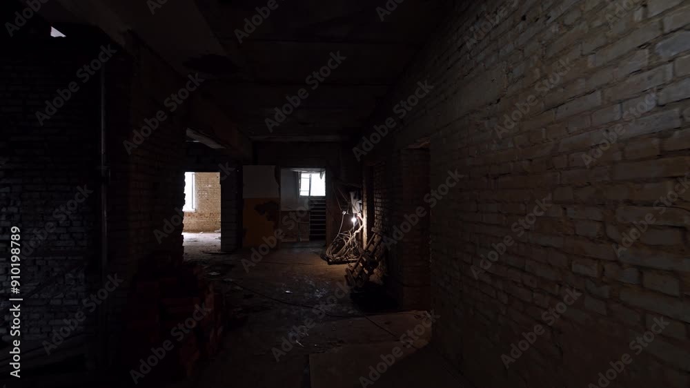 Dark empty premises of the building under construction. Old shabby house with multiple rooms. Dark empty premises of the building under construction. Old shabby house with multiple rooms.