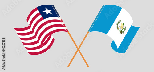 Crossed and waving flags of Liberia and Republic of Guatemala