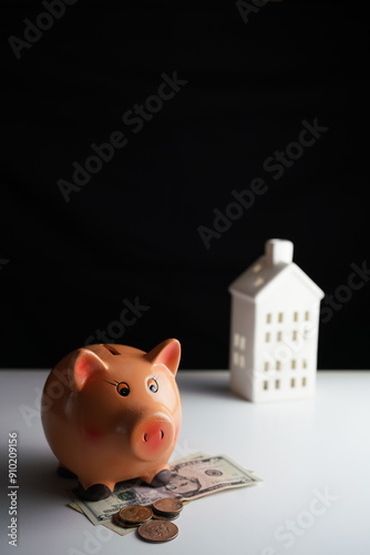Wallpaper Mural Vertical photo of various dollar bills and coins in a piggy bank in front of a residential building as a savings concept Torontodigital.ca