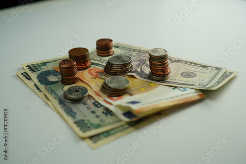 Wallpaper Mural Several dollar, euro and yen bills surrounded by coins of different currencies as a concept of foreign exchange purchase Torontodigital.ca