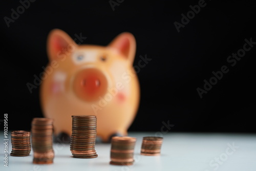 Wallpaper Mural coins of different currencies in front of a piggy bank out of focus in the background as a savings concept Torontodigital.ca