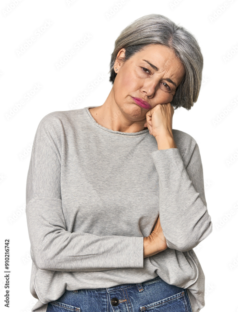 Caucasian mid-age female on studio background who feels sad and pensive, looking at copy space.