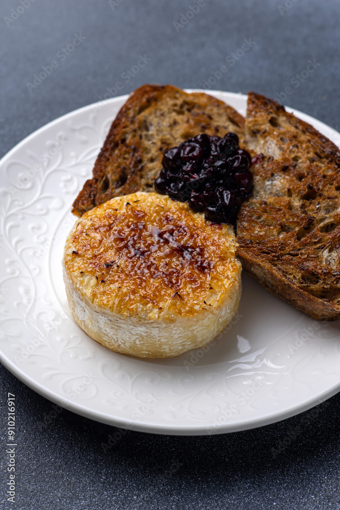 Grilled camembert cheese with black currant jam and toasted bread Grilled camembert cheese with black currant jam and toasted bread