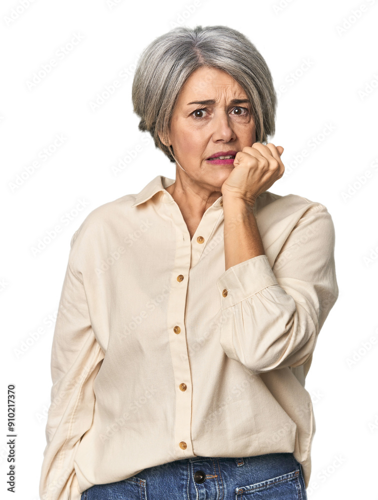 Caucasian mid-age female on studio background biting fingernails, nervous and very anxious. Caucasian mid-age female on studio background biting fingernails, nervous and very anxious.