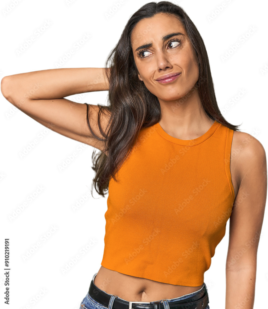 Fototapeta premium Hispanic young woman touching back of head, thinking and making a choice.