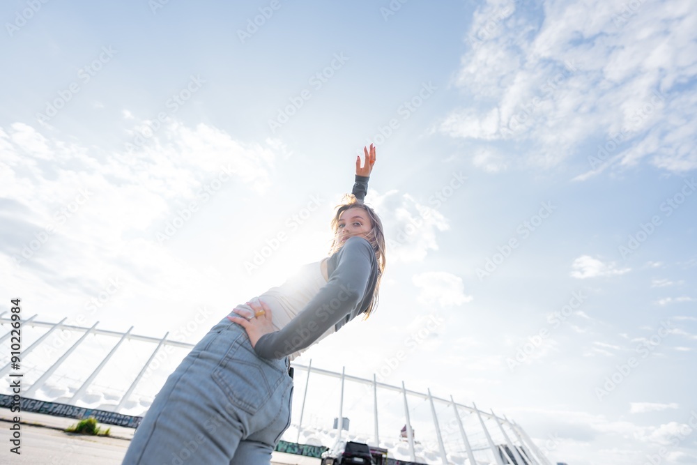 Young Woman Posing Joyfully Under Bright Sky at Outdoor Location During Daytime Young Woman Posing Joyfully Under Bright Sky at Outdoor Location During Daytime