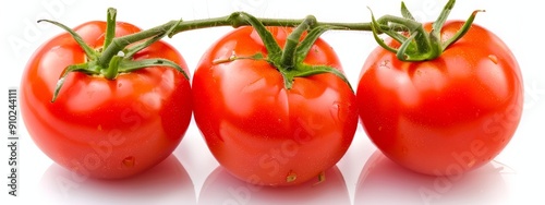  Three tomatoes align on a white surface, each touchingly close A solitary green stem rises from their midst photo