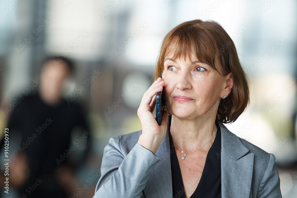 Diverse businesspeople are standing at the building corridor and talking together. Diverse businesspeople are standing at the building corridor and talking together.