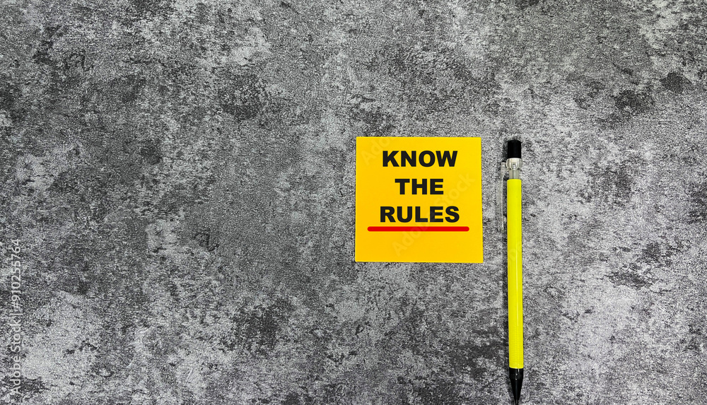 Concept of Know The Rules write on sticky notes isolated on Wooden Table. Concept of Know The Rules write on sticky notes isolated on Wooden Table.