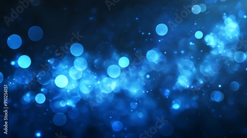 A mesmerizing blue abstract background filled with glowing circular bokeh lights, creating a tranquil and ethereal atmosphere.
