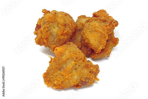Fried popcorn chicken close up isolated on white background with shadow. Chicken karaage or Japanese breaded fried chicken.
