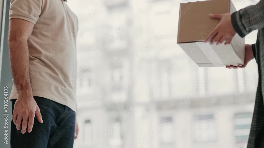 A close-up shot capturing the moment a courier hands over a delivery box to a client, symbolizing efficient service and the convenience of online shopping. A close-up shot capturing the moment a courier hands over a delivery box to a client, symbolizing efficient service and the convenience of online shopping.