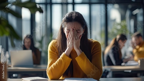 businesswoman or office worker sneezing in her office photo