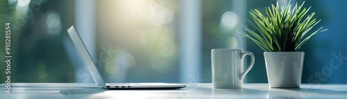 Modern workspace with open laptop, coffee mug, and plant on a bright and airy desk, perfect for productivity and focus.