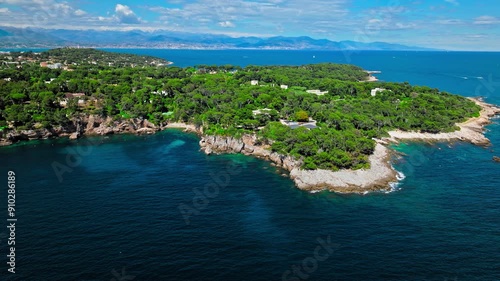 View from above of Billionaire Bay and rocky beach near coastal path on the Cap Antibes. Aerial view of the picturesque bay with luxurious villas, breathtaking views, and crystal-clear waters on Frenc photo
