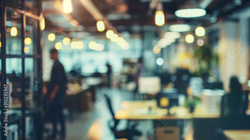 Blurred office interior with desks and workers. Abstract background of an office space with desks and employees blurred out of focus, providing a sense of bustling activity.