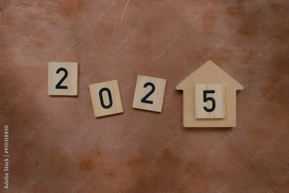 2025 Happy New Year with house model on copper background. Banking, real estate, savings, investment, financial, and New Year Resolution. 2025 Happy New Year with house model on copper background. Banking, real estate, savings, investment, financial, and New Year Resolution.
