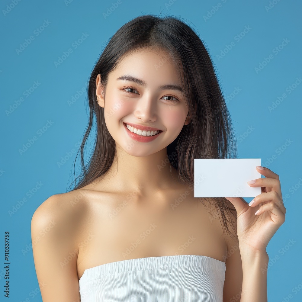 Cheerful Asian Woman Holding White Travel Card on Blue Background - Lifestyle Concept Cheerful Asian Woman Holding White Travel Card on Blue Background - Lifestyle Concept