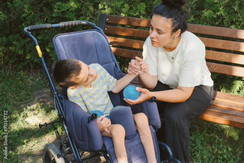 Mother and son with cerebral palsy enjoying time outdoors