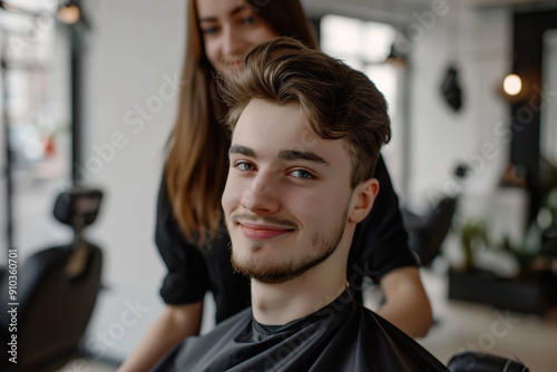 Hairdresser making hairstyle for young man in beauty hair salon