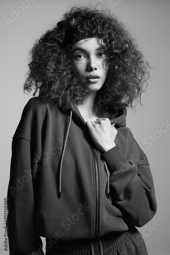 fashion black and white portrait of beautiful young woman in hoodie photo