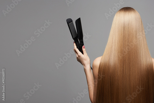 Back of girl with Healthy hair. Care and styling hair with iron