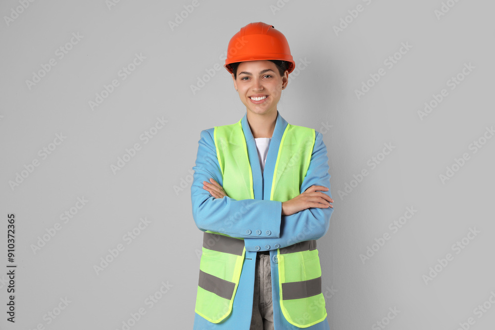 Engineer in hard hat on grey background Engineer in hard hat on grey background