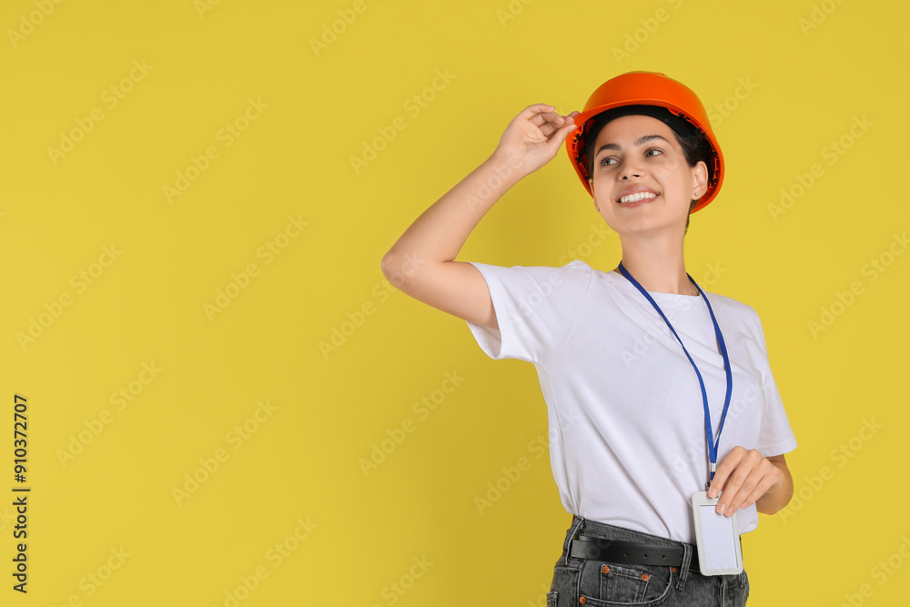 Engineer in hard hat on yellow background, space for text Engineer in hard hat on yellow background, space for text