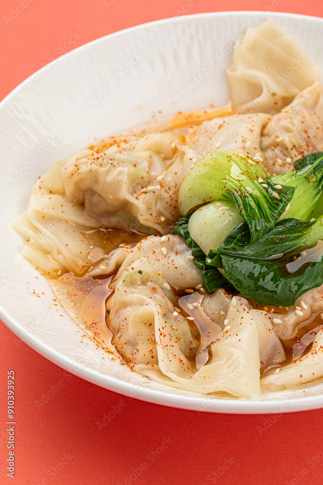 Portion of appetizing asian wonton dumplings with bok choi Portion of appetizing asian wonton dumplings with bok choi