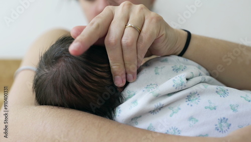 Slika na platnu Intimate close-up of a mother nursing and bonding with her newborn baby in her arms during the crucial first days of life