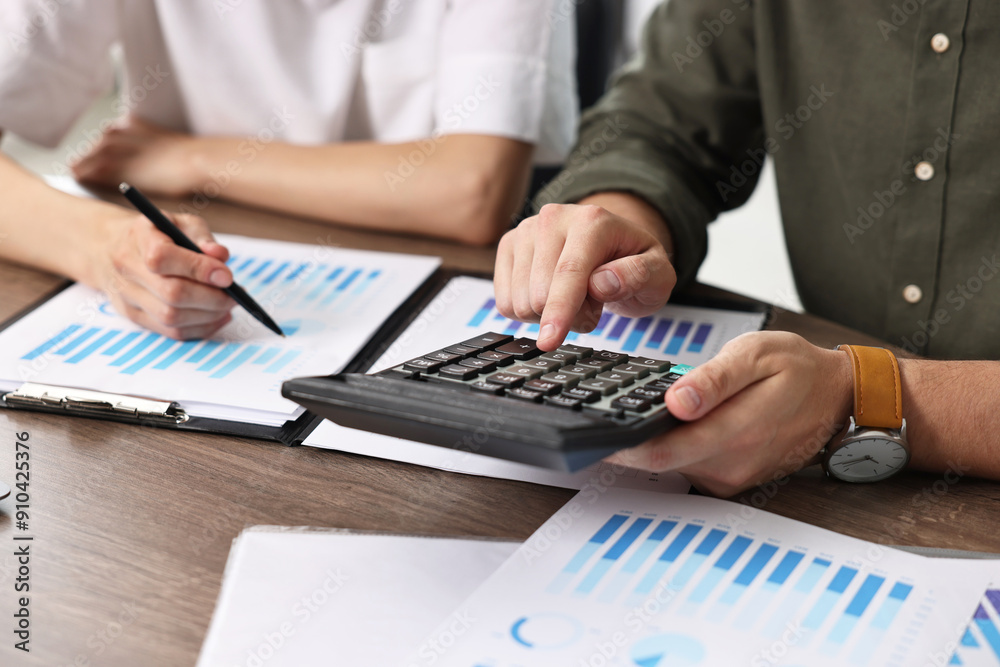 Consultant working with client at table in office, closeup Consultant working with client at table in office, closeup
