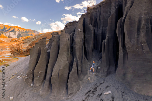 Adventure travel, tourist in hat explores landscape rock formations from stone Mushrooms in river valley, Altai mountains, Aerial top view photo