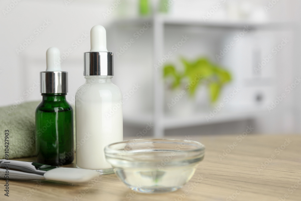 Peeling procedure. Bottles of chemical peel, bowl with liquid and brush on wooden table indoors. Space for text Peeling procedure. Bottles of chemical peel, bowl with liquid and brush on wooden table indoors. Space for text