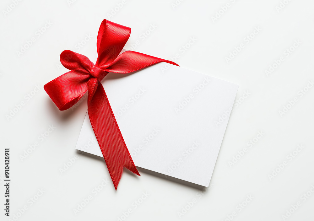 White card with red ribbon on isolated background, close up view, Blank Greeting and note for celebration or business gift decoration with copy space. White card with red ribbon on isolated background, close up view, Blank Greeting and note for celebration or business gift decoration with copy space.