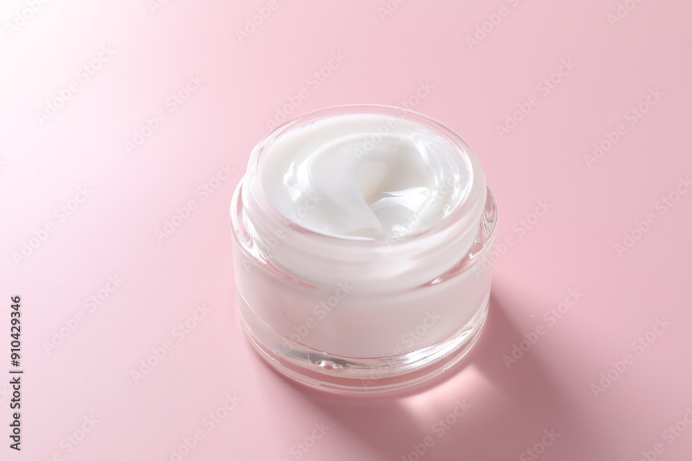 Face cream in jar on pink background, closeup Face cream in jar on pink background, closeup