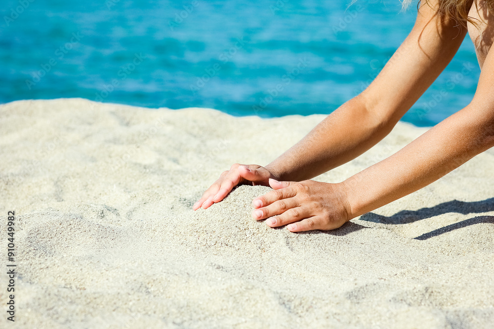 A hands pouring sand near the seashore on weekend nature travel A hands pouring sand near the seashore on weekend nature travel