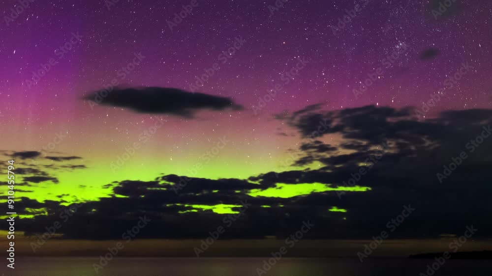 In a wide shot, the aurora borealis shines in the sky with green and purple hues, reflected on the lake's surface, as clouds pass by, creating a mesmerizing, colorful scene. In a wide shot, the aurora borealis shines in the sky with green and purple hues, reflected on the lake's surface, as clouds pass by, creating a mesmerizing, colorful scene.