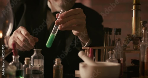 vintage scientist pouring chemical in test tube photo