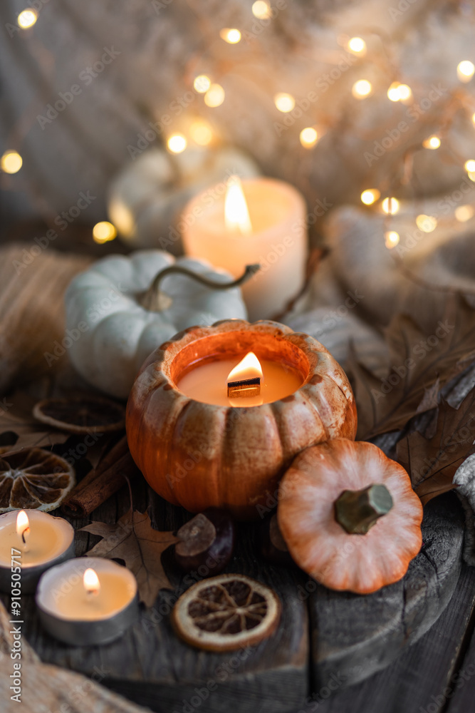 Atmospheric candle - shape of pumpkins, autumn decor on grey fall rainy day. Autumn cozy home atmosphere and inspiration, hygge concept. Aromatherapy, warming, relaxation. Wooden background Atmospheric candle - shape of pumpkins, autumn decor on grey fall rainy day. Autumn cozy home atmosphere and inspiration, hygge concept. Aromatherapy, warming, relaxation. Wooden background